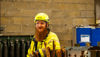 A man in workwear amongs scrap