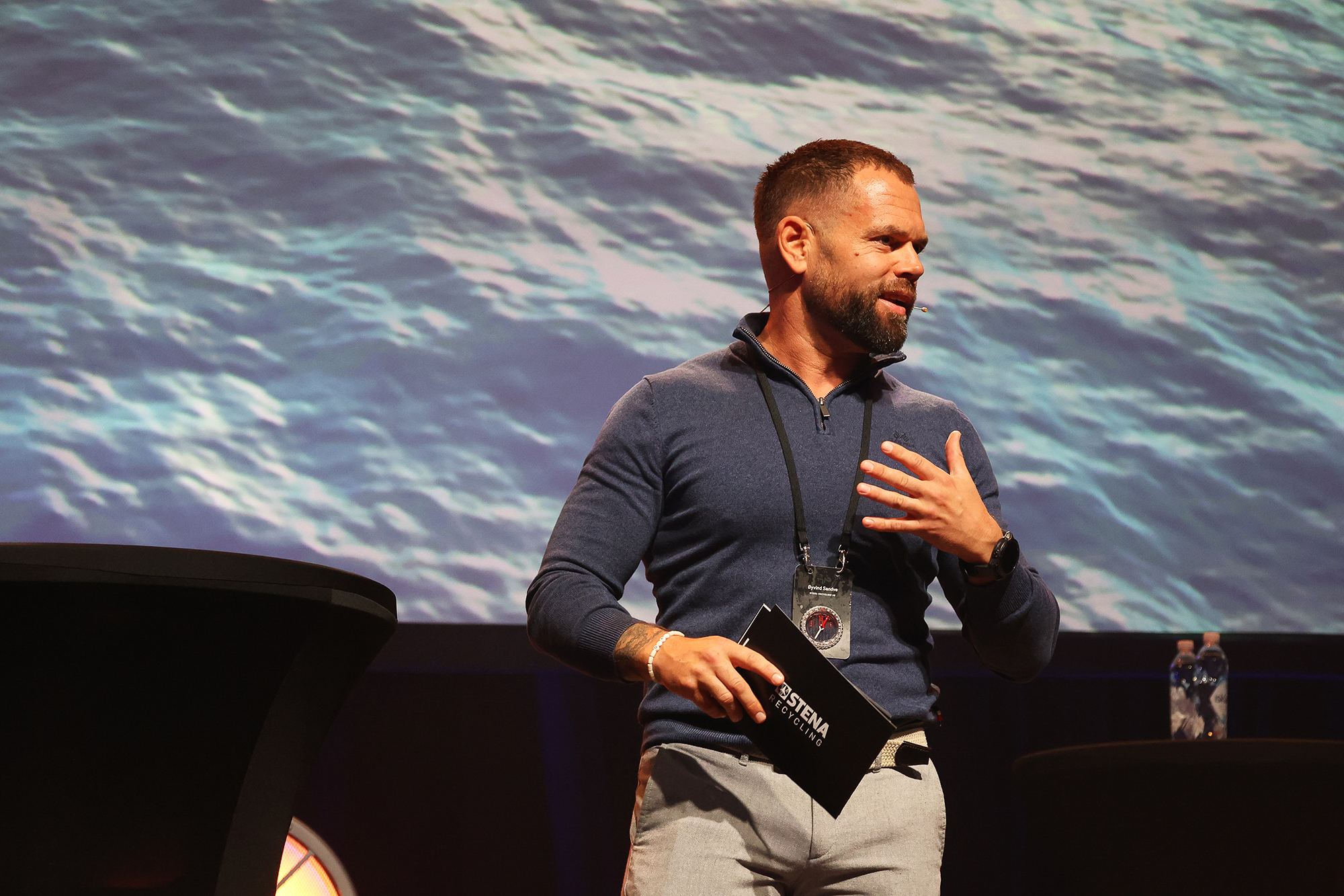 a man speaking passionatley on stage