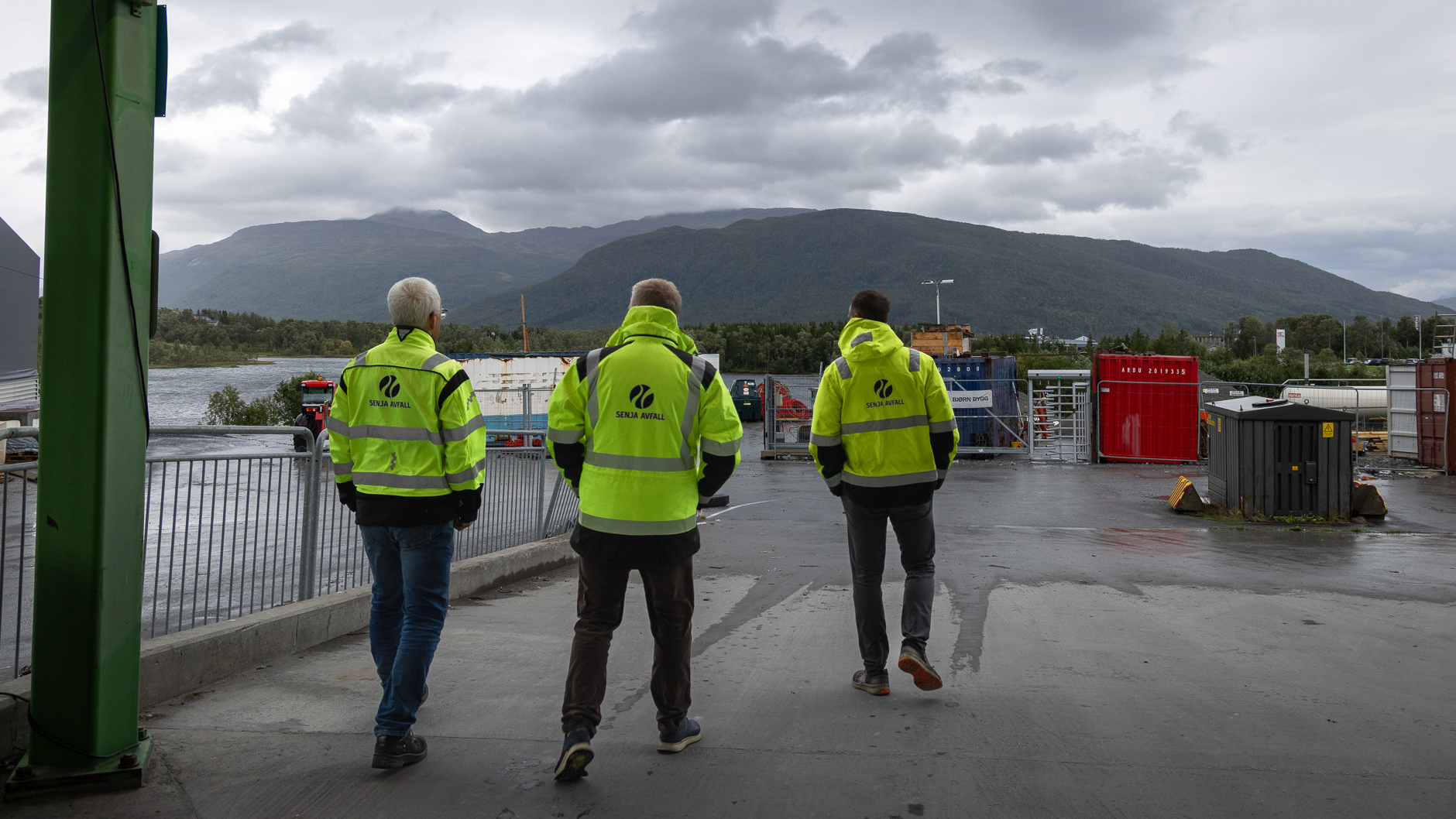 three men in workwear walking