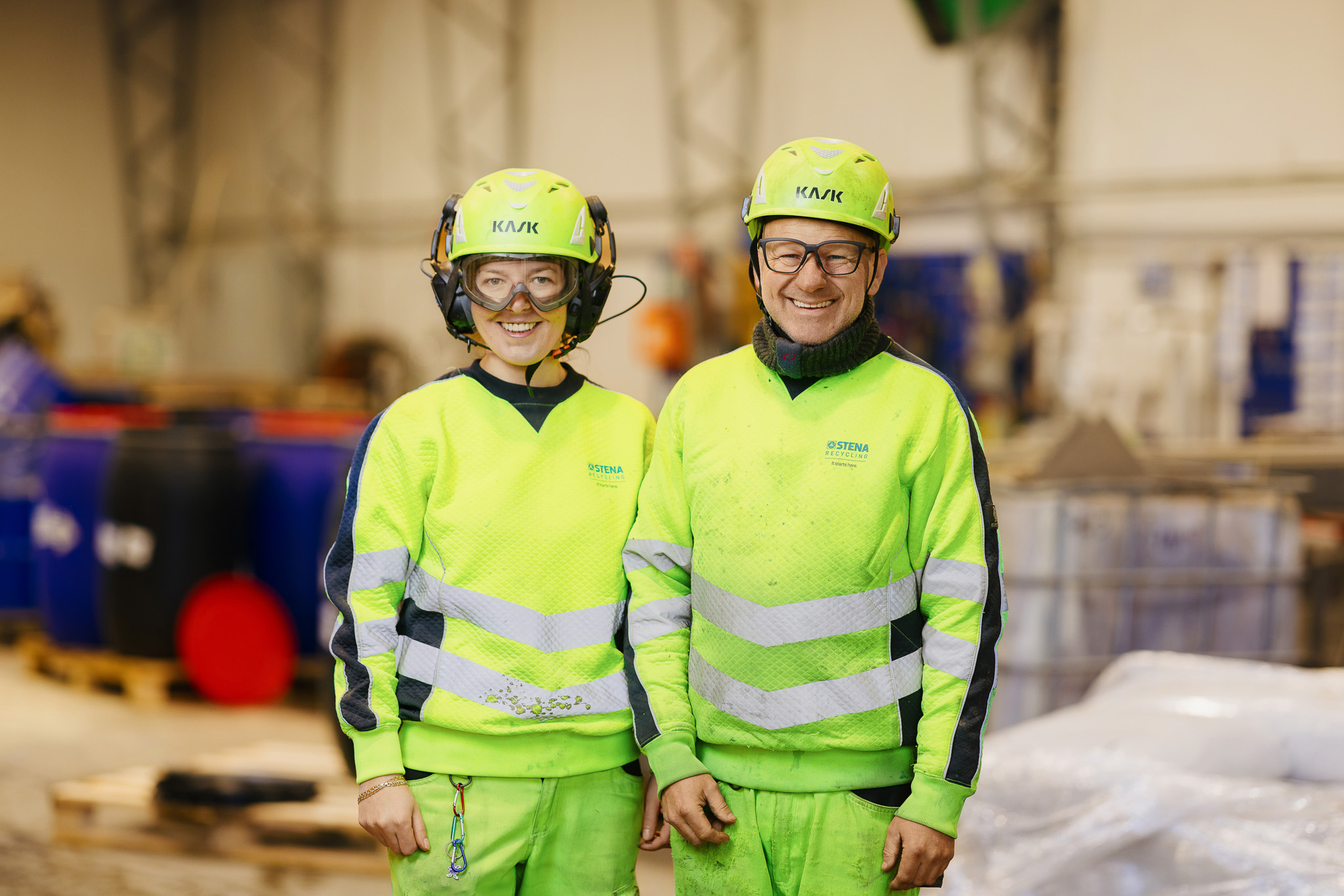 Two happy people in workwear