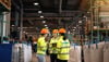 A group of three Stena Recycling Group employees talk at Stena Nordic Recycling Center, Halmstad, Sweden. 