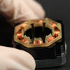 A hand gripping a compact device powered by a small battery, showcasing the intersection of technology and portability