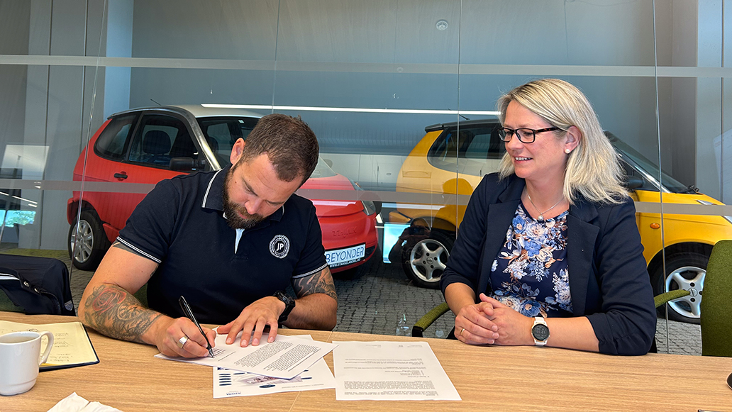 Two people signing a contract