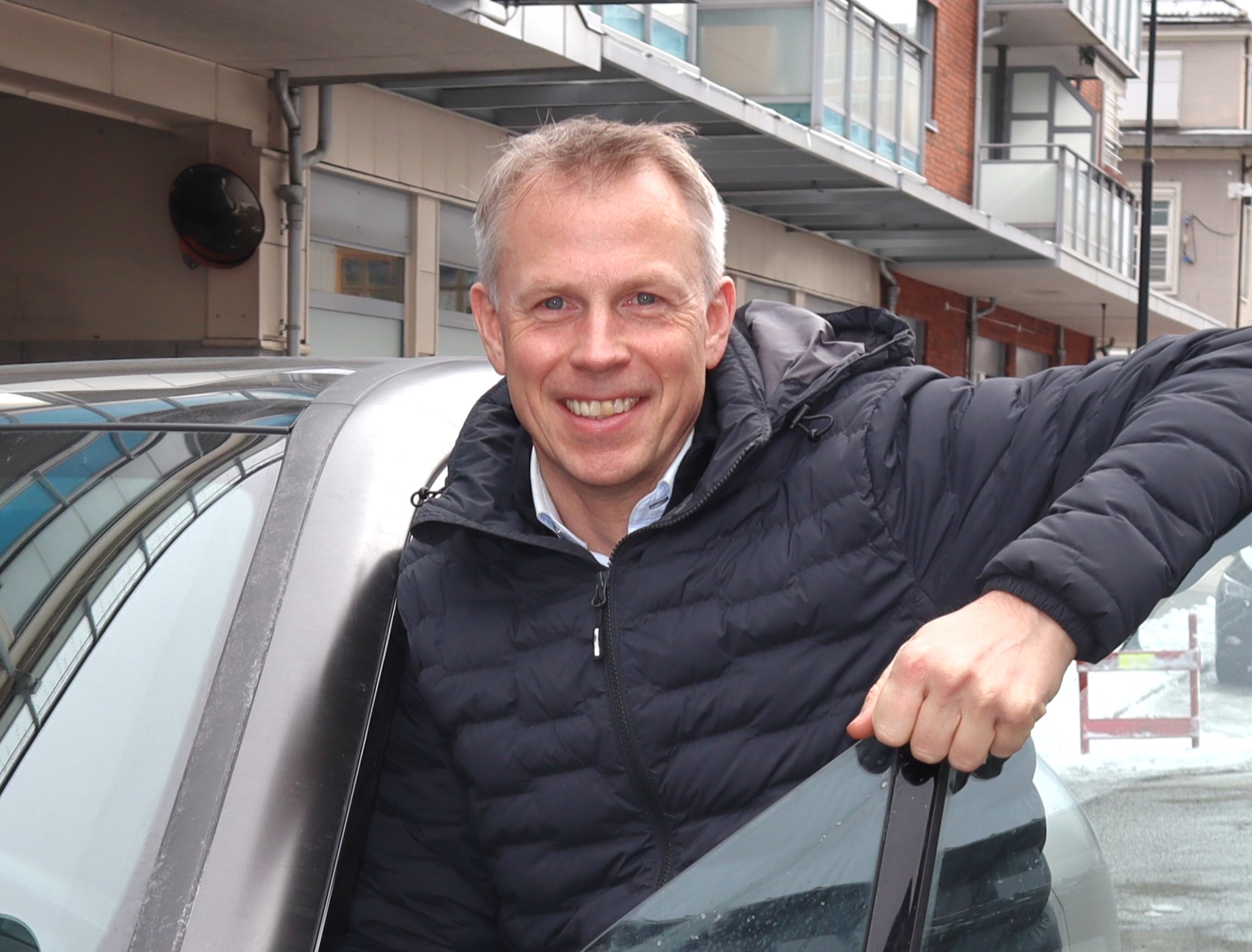 Jon Emil by a car door