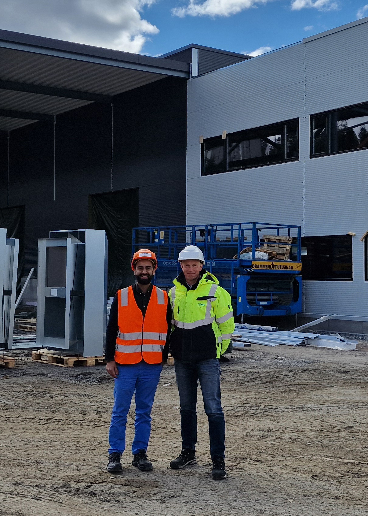 Two men in front of a building