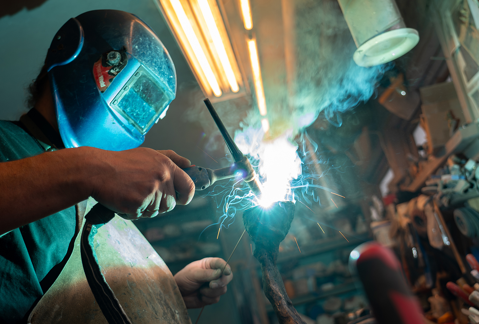 Man welding a sculpture