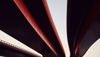 Three red motorway flyovers over a railway line. 