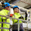 Two Stena Recycling employees conversing in a recycling facility