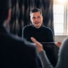A Stena Recycling battery expert answers questions in an office environment.