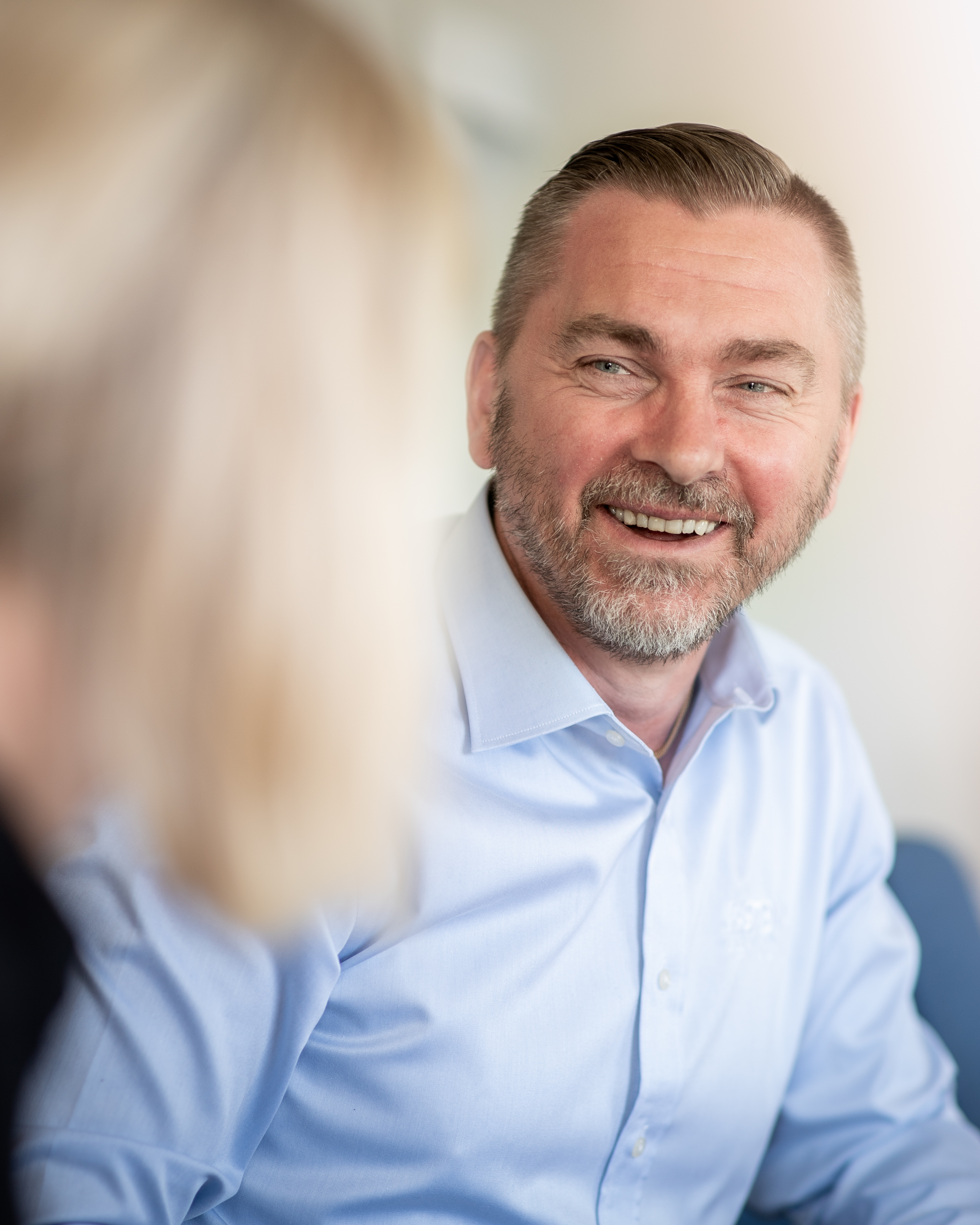 A smiling Stena Recycling employee in an office.