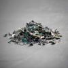 A small pile of granulated electronic parts on concrete.