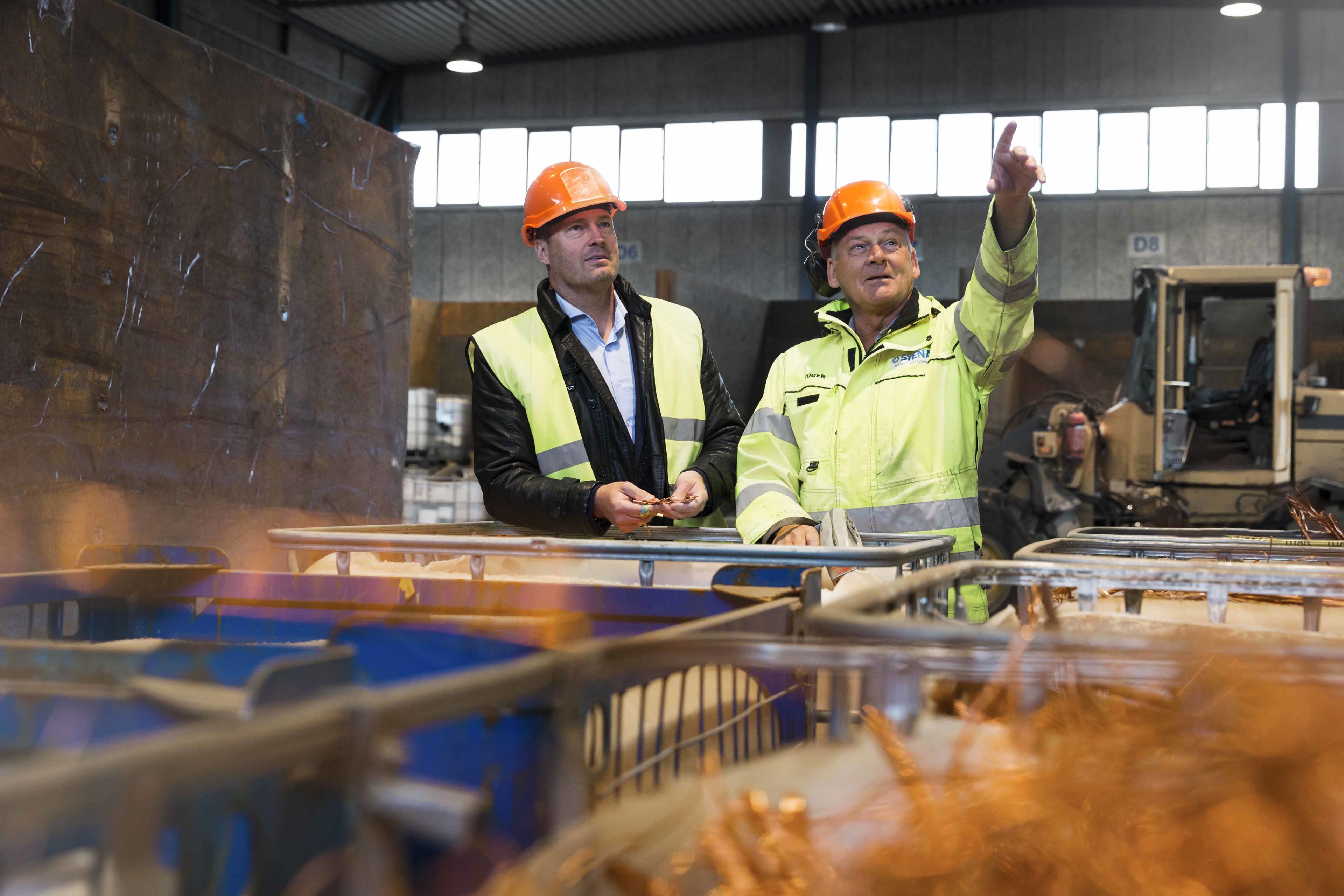 Rtena recycling employee discussing with customer