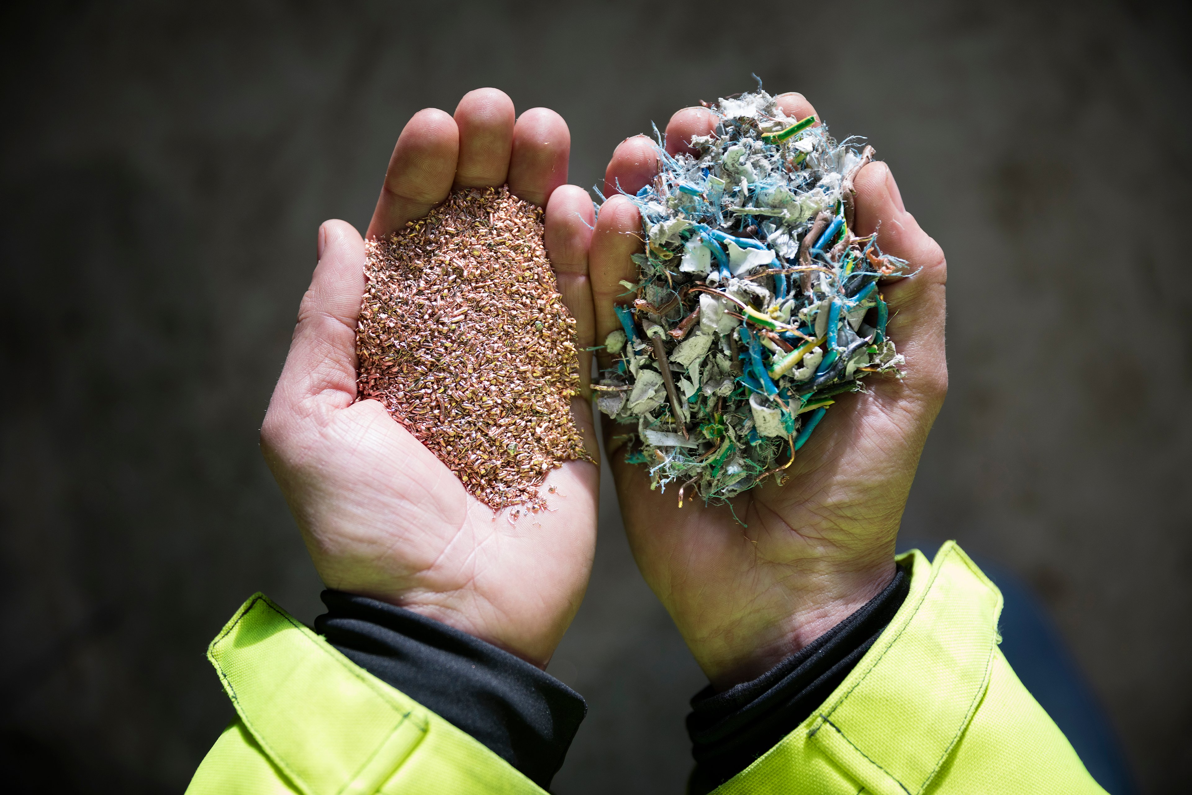 A close-up of a Stena Recycling expert's hands as they hold material ready for recycling.