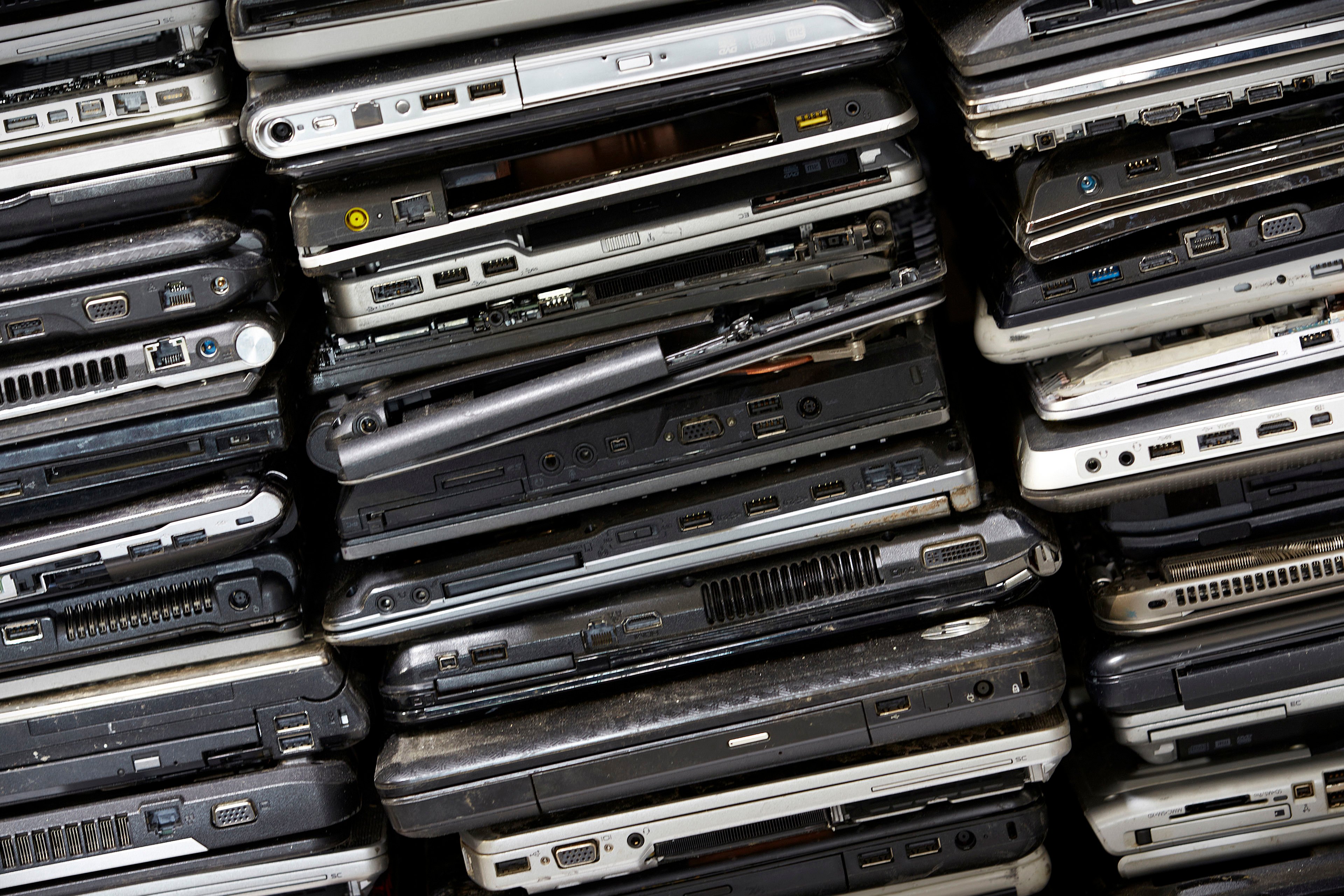 A pile of laptop computers ready to be reused or recycled by Stena Recycling.